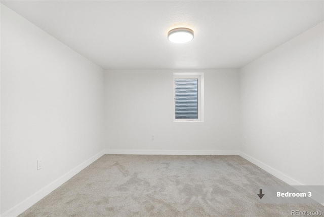 spare room with light colored carpet