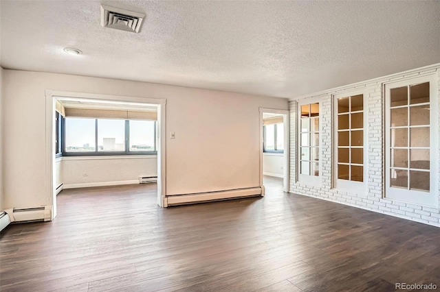 3131 E Alameda Ave Unit 1503, Denver, CO 80209 - spare room featuring a baseboard radiator, a textured ceiling, and dark wood-style flooring