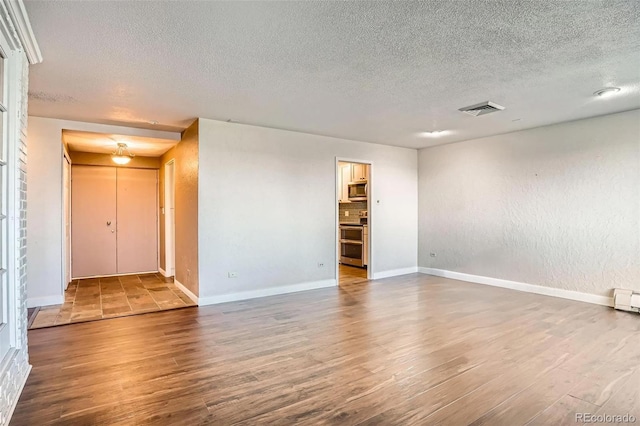 3131 E Alameda Ave Unit 1503, Denver, CO 80209 - spare room with a textured ceiling and wood finished floors