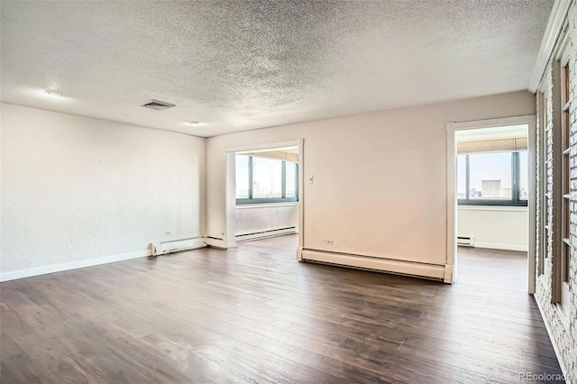 3131 E Alameda Ave Unit 1503, Denver, CO 80209 - empty room with a baseboard heating unit, plenty of natural light, a textured ceiling, and baseboard heating