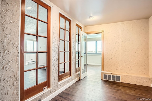 3131 E Alameda Ave Unit 1503, Denver, CO 80209 - unfurnished room featuring a textured wall, dark wood-style flooring, and baseboards