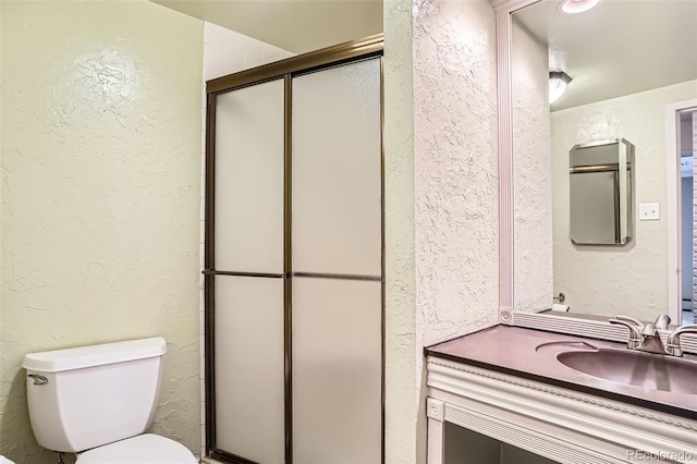 3131 E Alameda Ave Unit 1503, Denver, CO 80209 - bathroom featuring a textured wall, a shower stall, and vanity