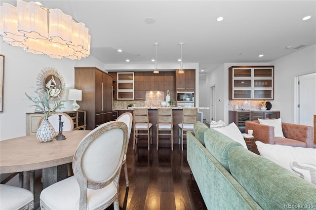 dining area featuring dark wood-type flooring and beverage cooler