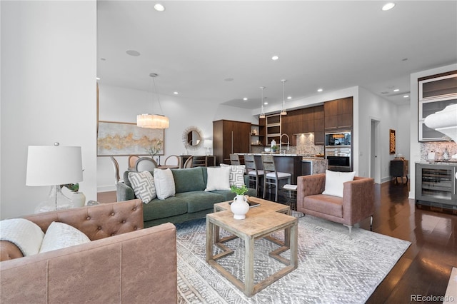 living room with beverage cooler and hardwood / wood-style floors