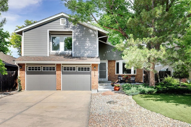 view of front of property with fence, brick siding, a garage, a front yard, and concrete driveway