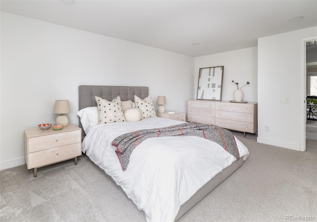 bedroom featuring baseboards and carpet