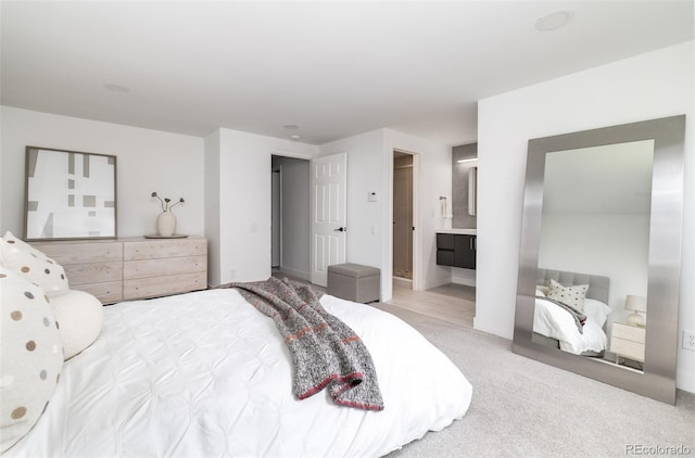 bedroom featuring carpet flooring and ensuite bath