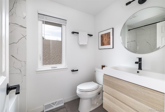 bathroom with visible vents, vanity, baseboards, tile patterned floors, and toilet