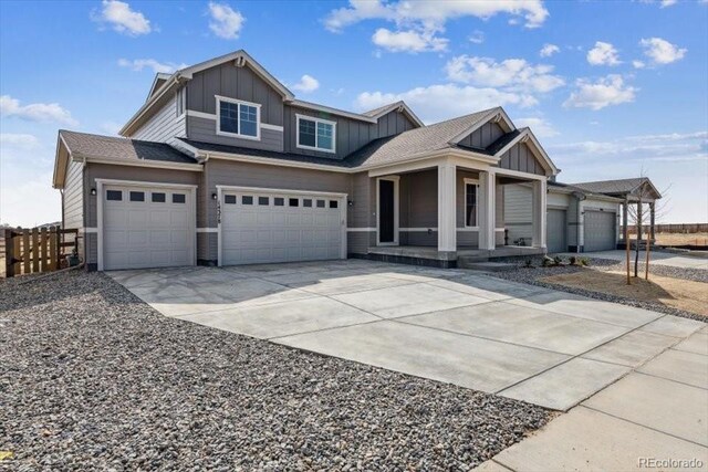 14378 Heritage Dr, Mead, CO 80504 - craftsman-style house featuring board and batten siding, covered porch, fence, concrete driveway, and an attached garage