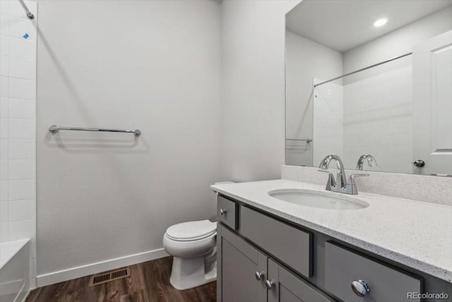 14378 Heritage Dr, Mead, CO 80504 - full bath with visible vents, vanity, wood finished floors, toilet, and baseboards