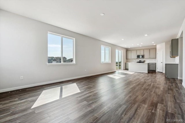 14378 Heritage Dr, Mead, CO 80504 - unfurnished living room featuring baseboards, recessed lighting, and dark wood-style floors