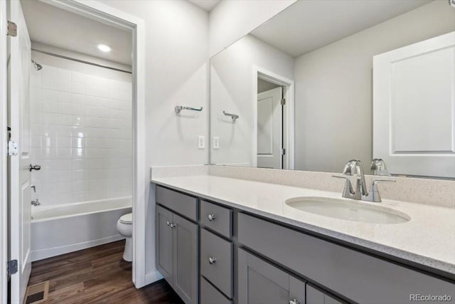 14378 Heritage Dr, Mead, CO 80504 - bathroom featuring vanity, bathing tub / shower combination, toilet, and wood finished floors