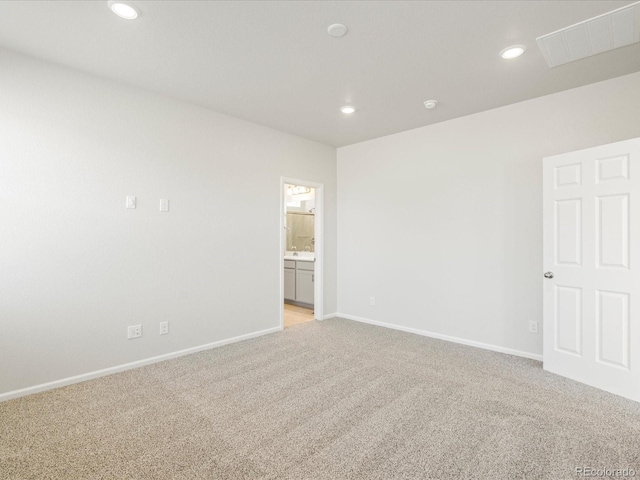 unfurnished room featuring light carpet, baseboards, visible vents, and recessed lighting