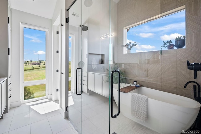 bathroom featuring tile patterned floors and independent shower and bath