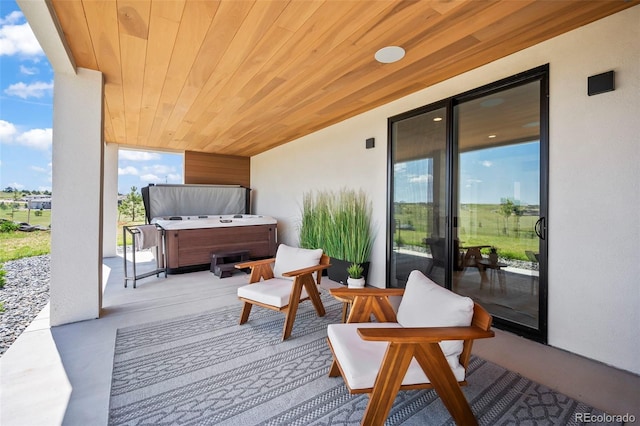 wooden terrace with a hot tub