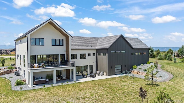 back of house featuring a balcony, a yard, central AC unit, and a patio area