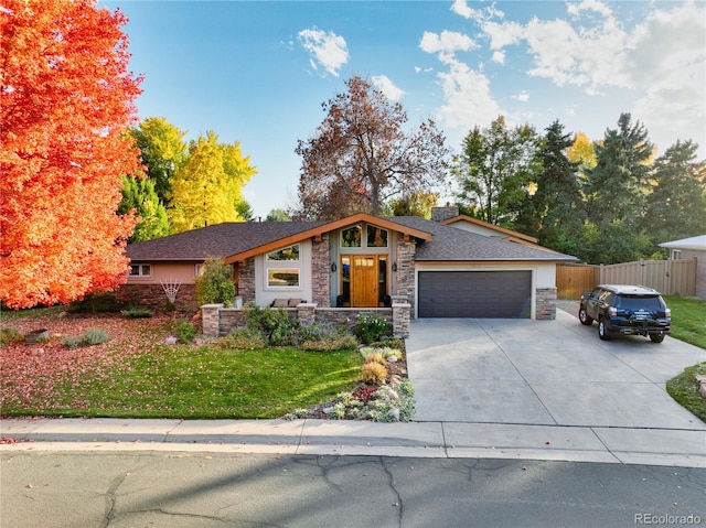 view of front of home with a front yard and a garage