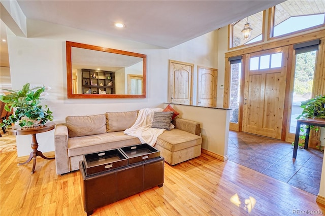 living room with light hardwood / wood-style floors and lofted ceiling