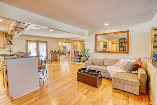 living room featuring french doors and light wood-type flooring