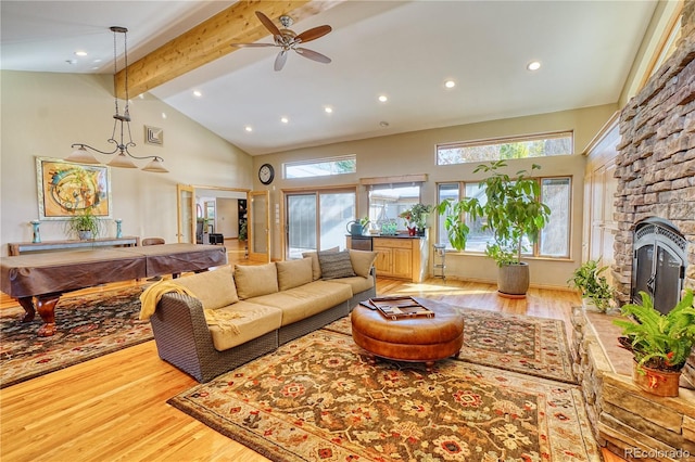 living room featuring wood-type flooring, billiards, a healthy amount of sunlight, and beam ceiling