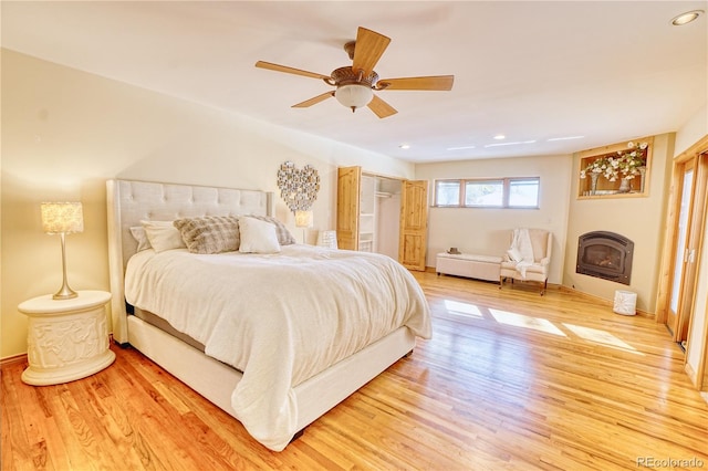 bedroom with ceiling fan and hardwood / wood-style flooring