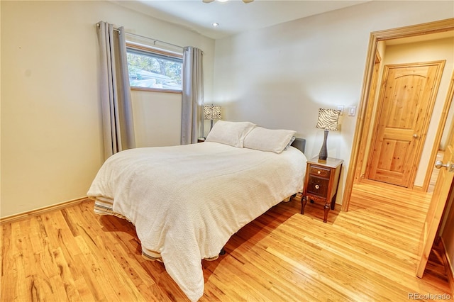 bedroom featuring hardwood / wood-style floors and ceiling fan