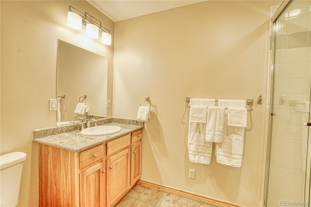 bathroom with tile patterned flooring, vanity, a shower with shower door, and toilet