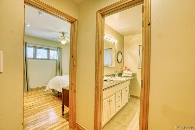 bathroom with ceiling fan, wood-type flooring, and vanity