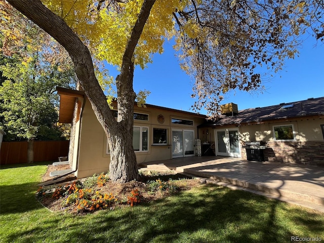 back of house featuring a yard and a patio area