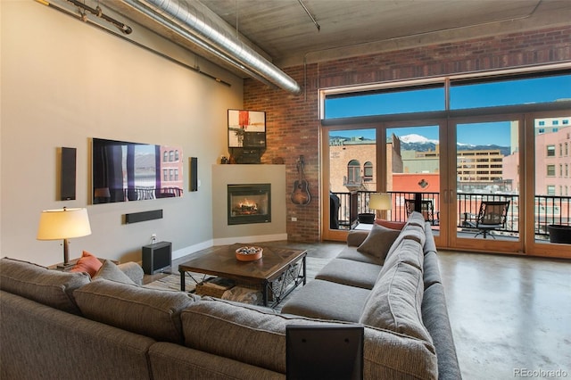 living room with concrete floors and brick wall