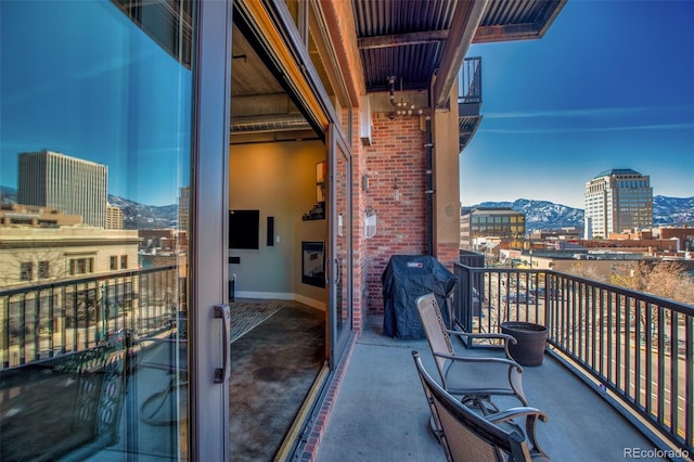 balcony featuring a mountain view and area for grilling