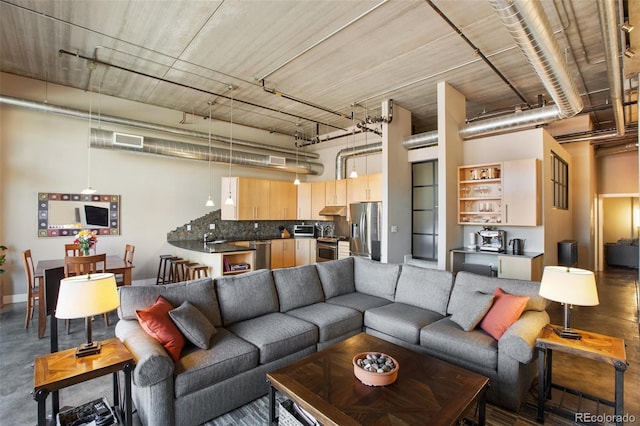 living room featuring a high ceiling