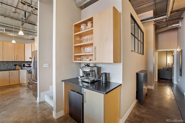 bar featuring light brown cabinets, a high ceiling, decorative backsplash, decorative light fixtures, and stainless steel refrigerator