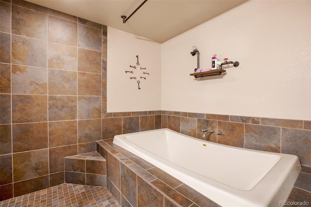 bathroom with tile patterned floors and tiled bath