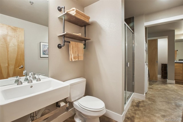 bathroom with sink, an enclosed shower, and toilet