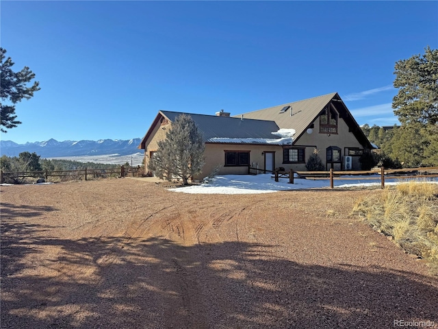 view of front of property featuring a mountain view and a patio