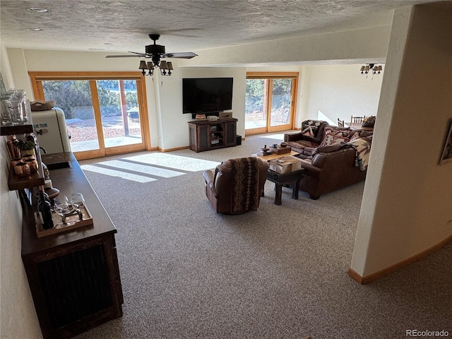 living room featuring carpet, a textured ceiling, and a wealth of natural light