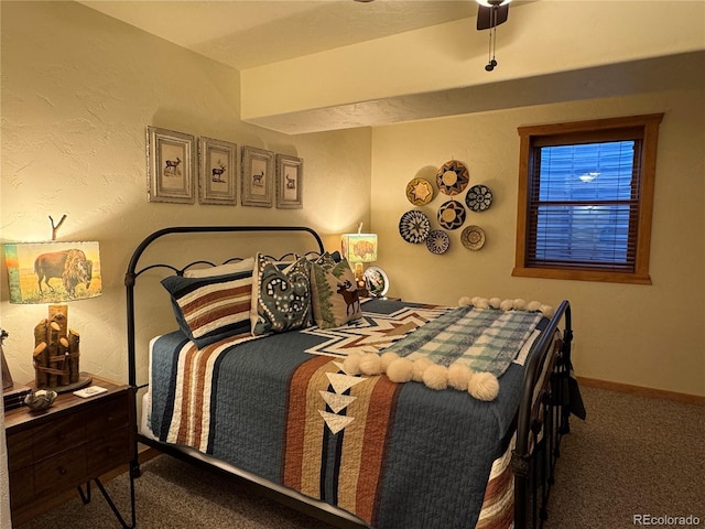 bedroom with ceiling fan and dark carpet