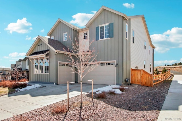 view of front of property with board and batten siding, an attached garage, driveway, and a shingled roof