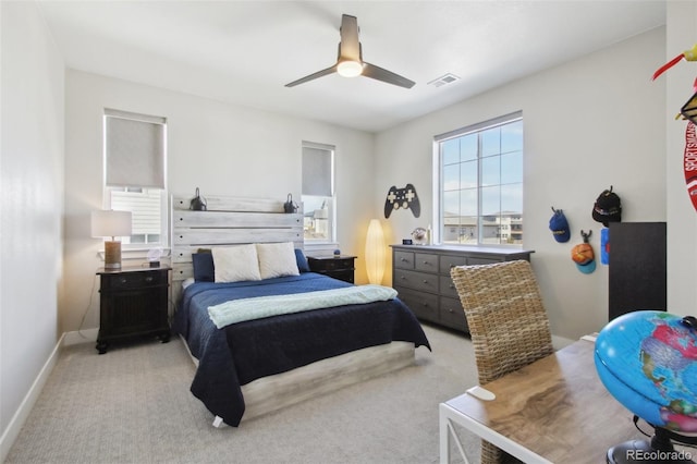 carpeted bedroom featuring a ceiling fan, baseboards, and visible vents