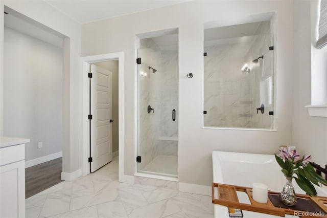 full bath with a bath, baseboards, marble finish floor, and a marble finish shower