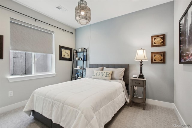 carpeted bedroom with visible vents and baseboards