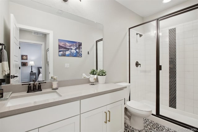 full bath with vanity, a shower stall, toilet, and visible vents