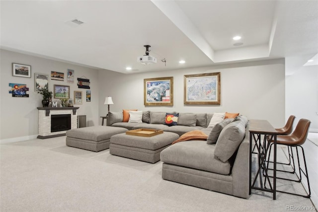 carpeted living room with recessed lighting, baseboards, and a fireplace