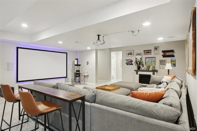 cinema room with recessed lighting and a fireplace