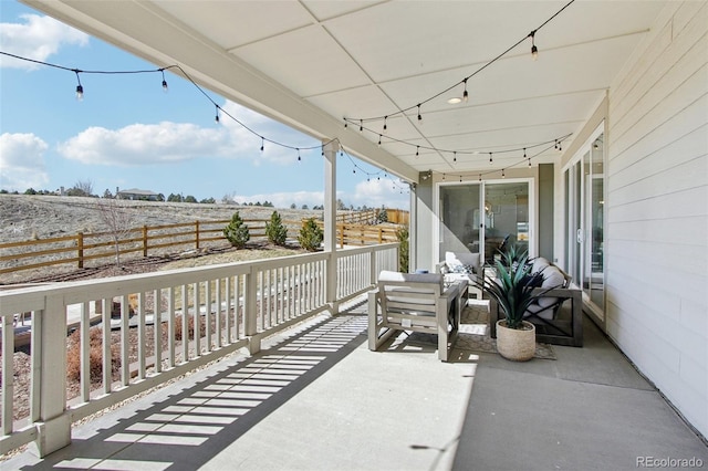 balcony with a rural view and a sunroom