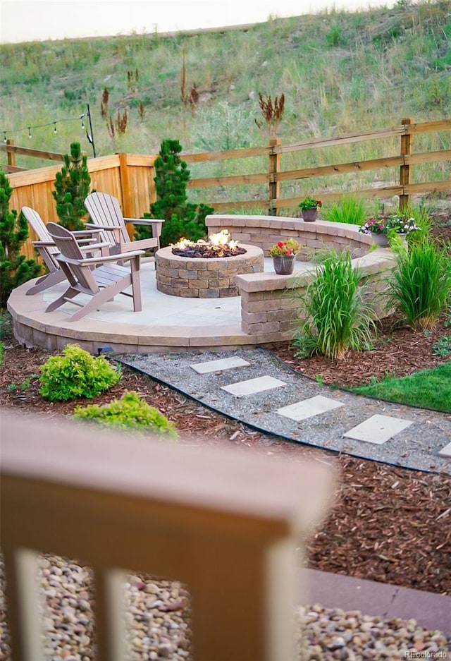 view of yard with a patio area, an outdoor fire pit, and fence