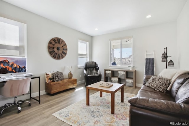 living area featuring recessed lighting, baseboards, and wood finished floors