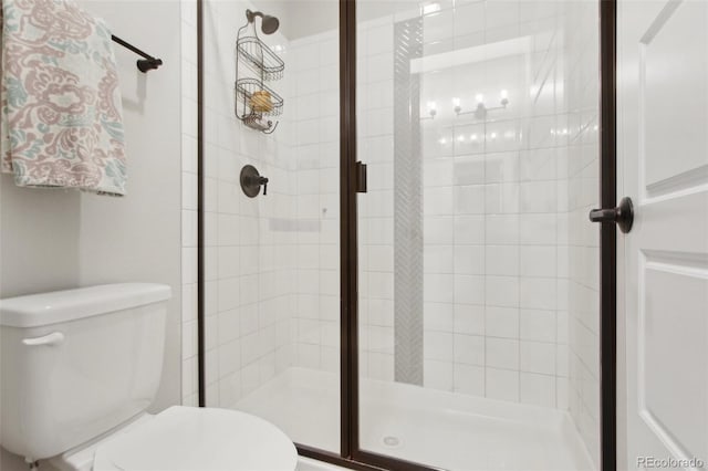 bathroom with toilet and a stall shower