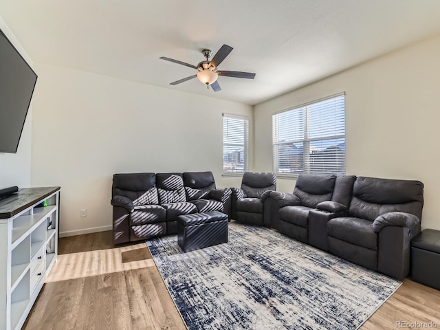 living room featuring ceiling fan and hardwood / wood-style flooring